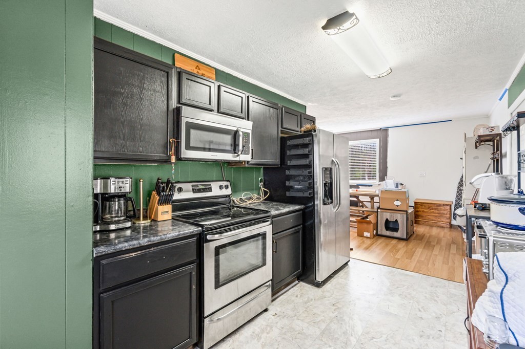 939 Watauga Road Cookeville, TN 38506 - Photo 2 of 28 a kitchen with stainless steel appliances kitchen island granite countertop a stove and cabinets