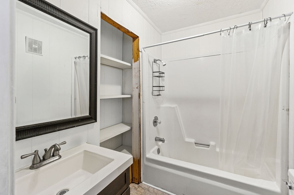 939 Watauga Road Cookeville, TN 38506 - Photo 8 of 28 a bathroom with a sink and a mirror