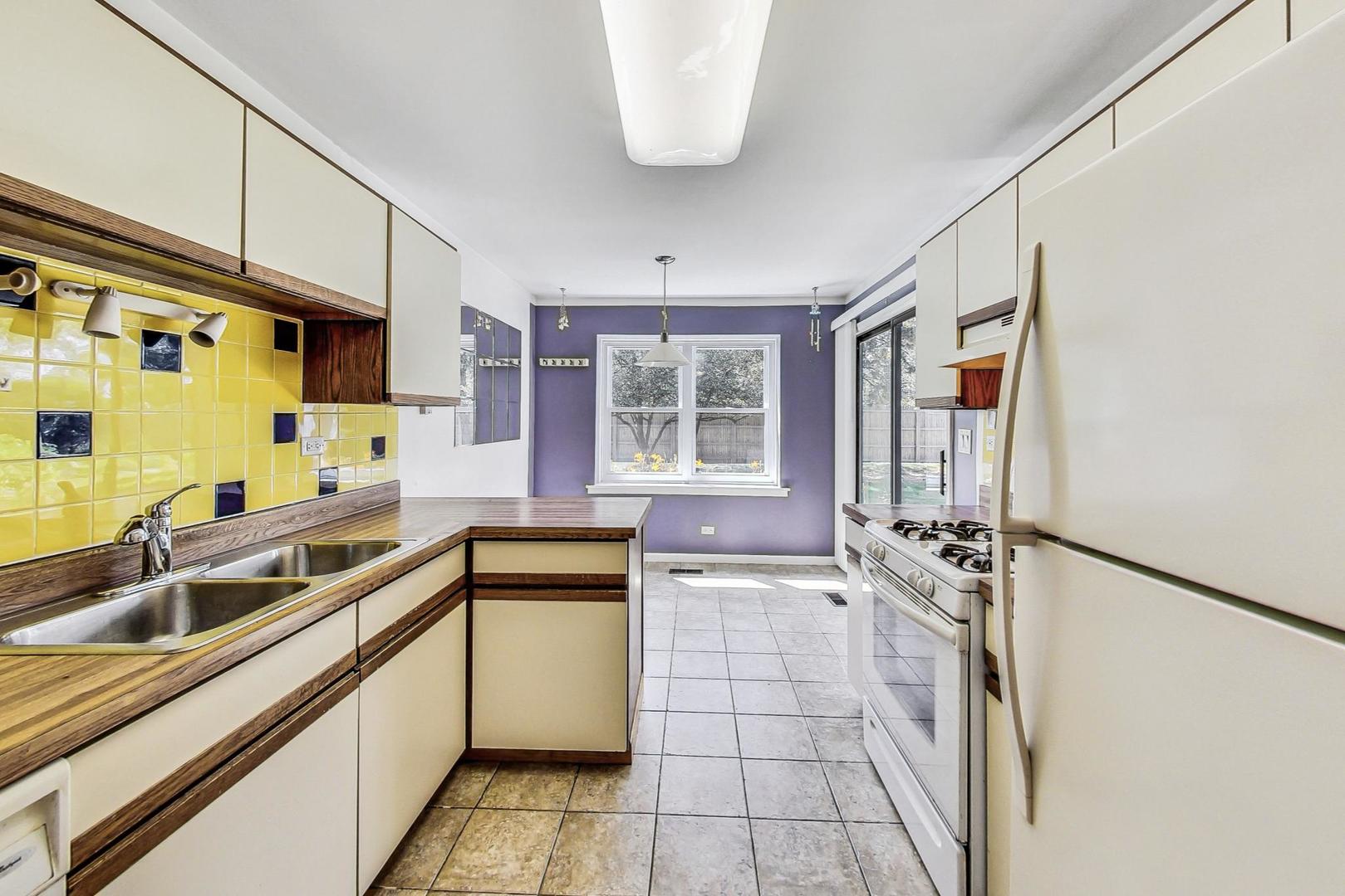 2980 Northampton Drive, Unit D1 Rolling Meadows, IL 60008 - Photo 12 of 35 a kitchen with stainless steel appliances a sink stove and cabinets
