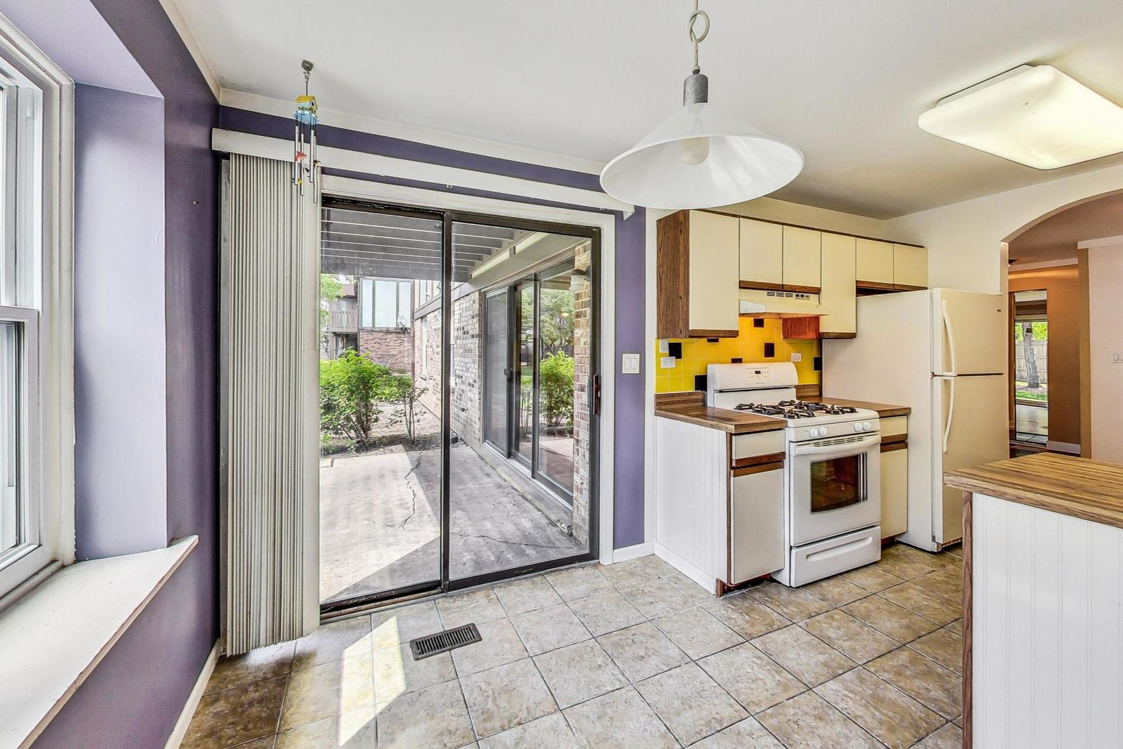 2980 Northampton Drive, Unit D1 Rolling Meadows, IL 60008 - Photo 15 of 35 a kitchen with stainless steel appliances a stove a sink and a refrigerator