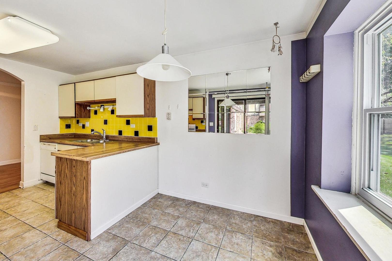 2980 Northampton Drive, Unit D1 Rolling Meadows, IL 60008 - Photo 16 of 35 a kitchen with stainless steel appliances granite countertop a stove and a refrigerator