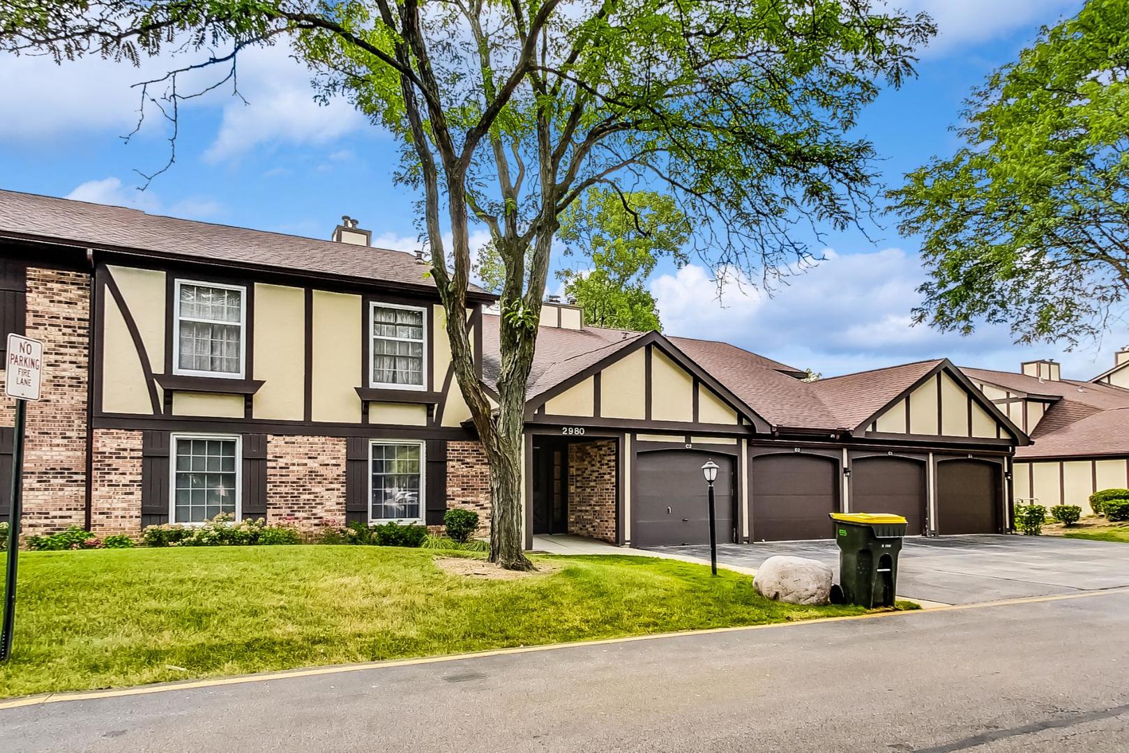 2980 Northampton Drive, Unit D1 Rolling Meadows, IL 60008 - Photo 2 of 35 a front view of a house with a yard