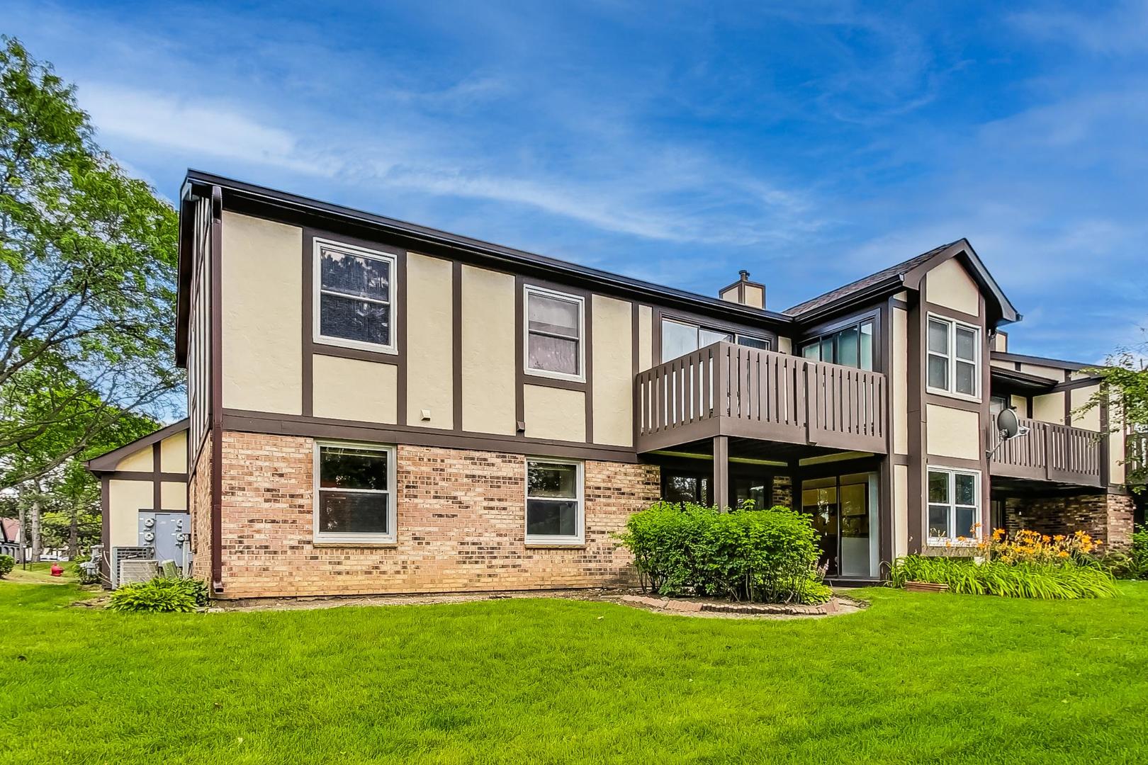 2980 Northampton Drive, Unit D1 Rolling Meadows, IL 60008 - Photo 30 of 35 a front view of a house with a garden