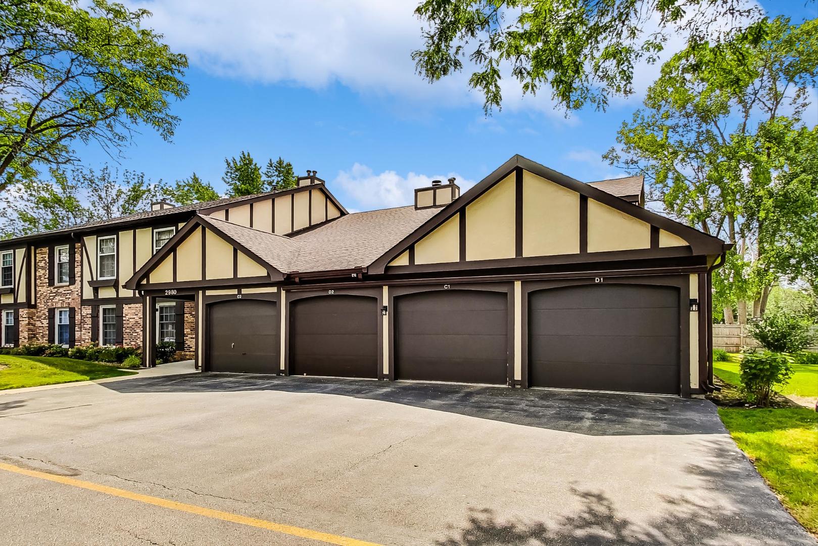 2980 Northampton Drive, Unit D1 Rolling Meadows, IL 60008 - Photo 35 of 35 a front view of a house with a yard and garage