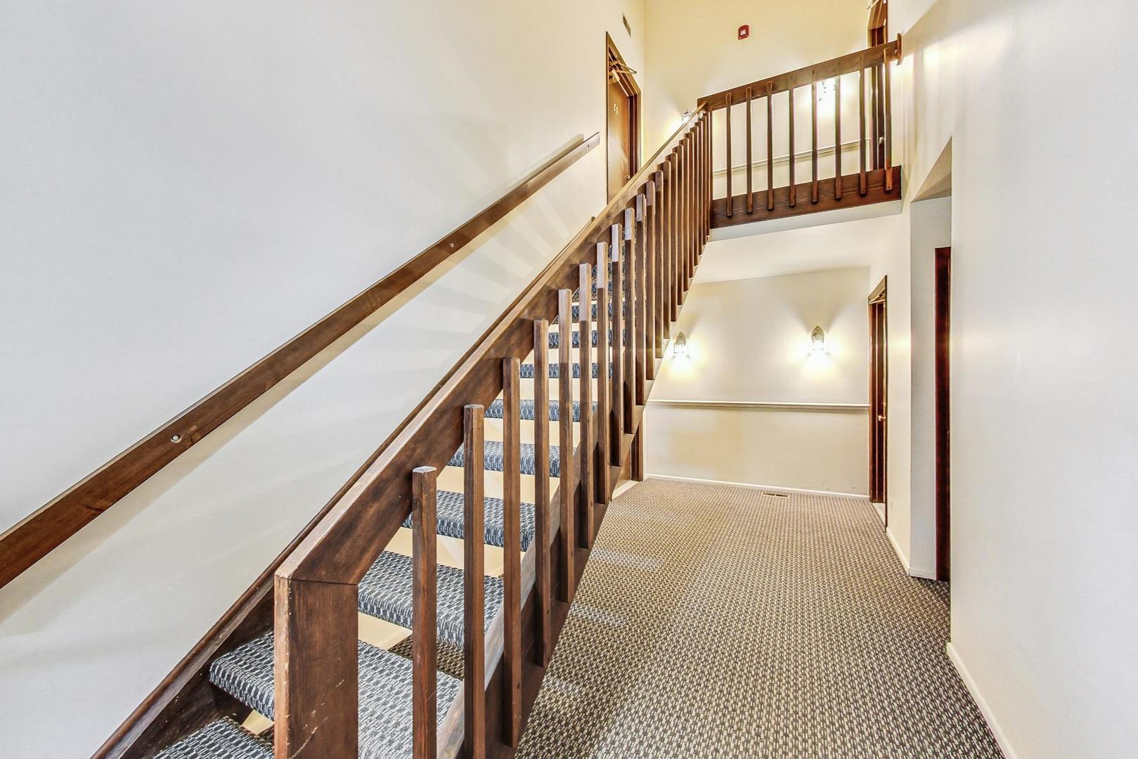 2980 Northampton Drive, Unit D1 Rolling Meadows, IL 60008 - Photo 5 of 35 a view of staircase with railing and a window
