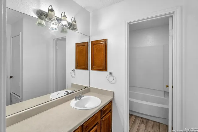 a bathroom with a sink a vanity and a mirror