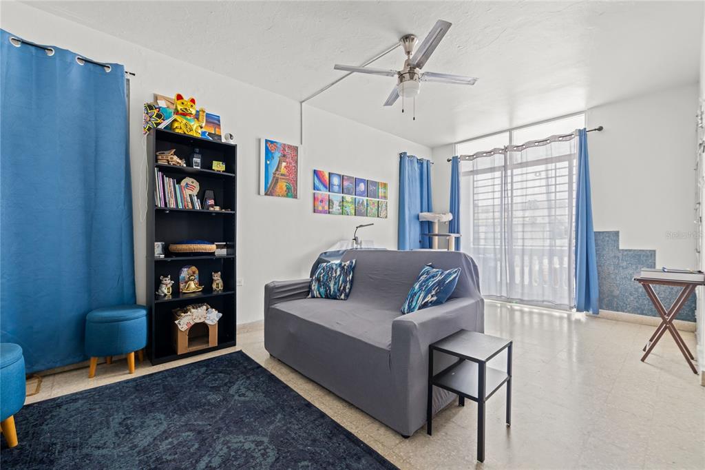 228 Calle 25 Guaynabo, Guaynabo 00969 - Photo 5 of 10 a living room with furniture a bookshelf and a window
