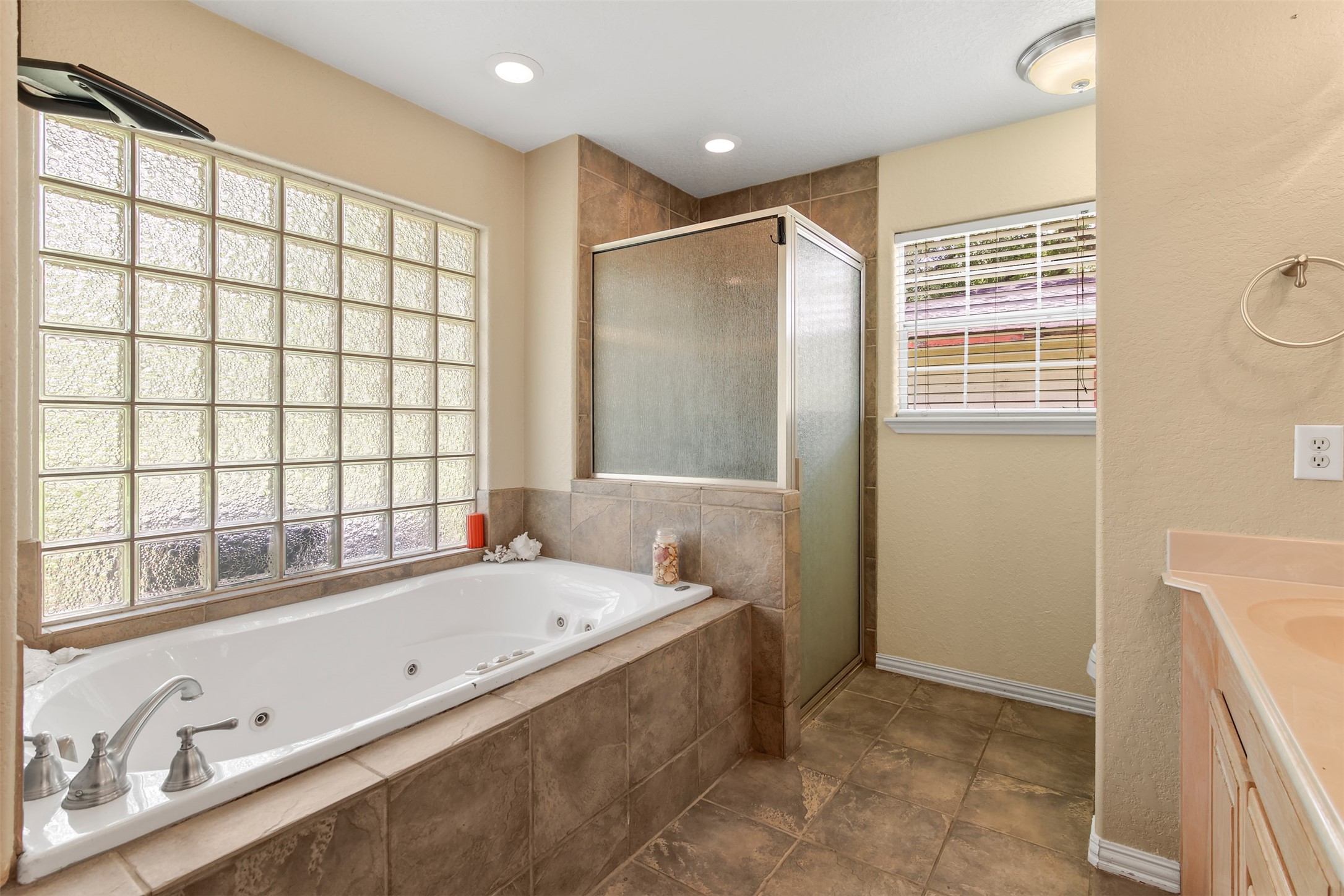 11692 Clark Lane Conroe, TX 77385 - Photo 12 of 35 The primary bathroom has an oversized jetted tub with glass block obscure window and separate walk-in shower.