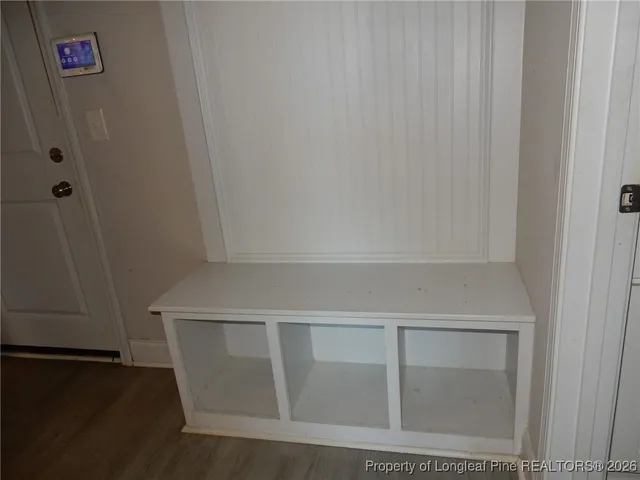 a view of a room with wooden floor