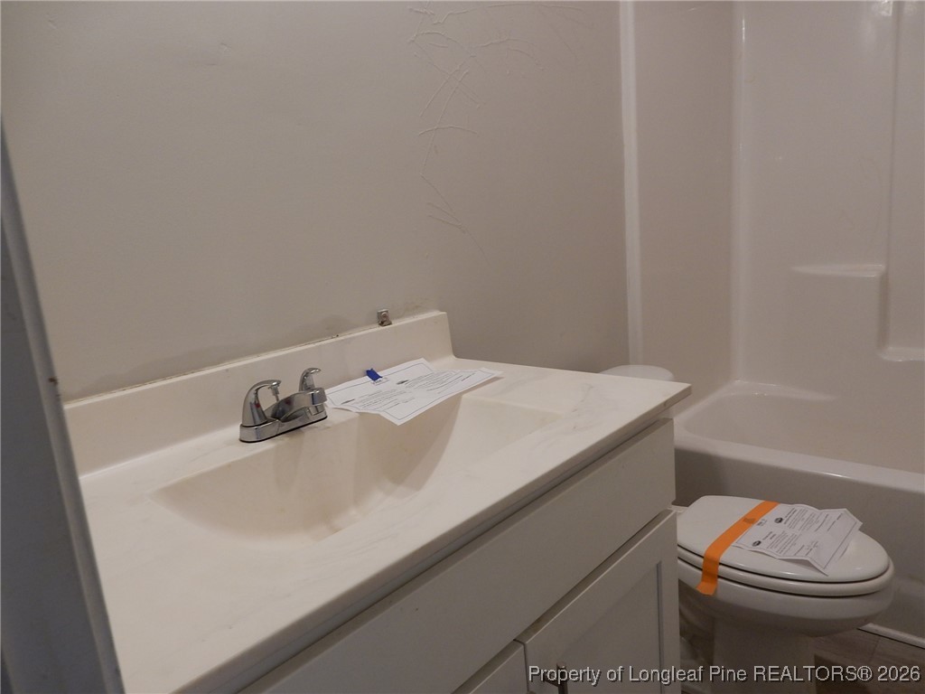 111 South Dakota Court Spring Lake, NC 28390 - Photo 13 of 29 a bathroom with a sink toilet and vanity