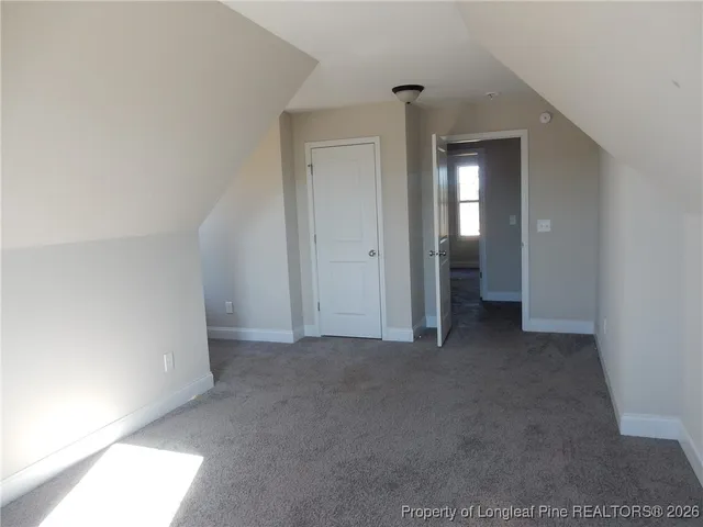 a view of a house with a large window and a yard