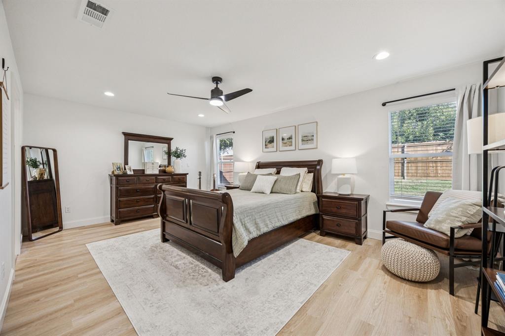 1609 Knight Trail Little Elm, TX 75036 - Photo 11 of 28 a spacious bedroom with a bed a window and a couch