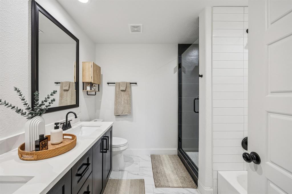 1609 Knight Trail Little Elm, TX 75036 - Photo 14 of 28 a bathroom with a sink and a mirror
