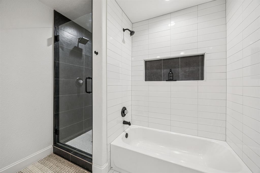 1609 Knight Trail Little Elm, TX 75036 - Photo 16 of 28 a bathroom with a bathtub and a shower