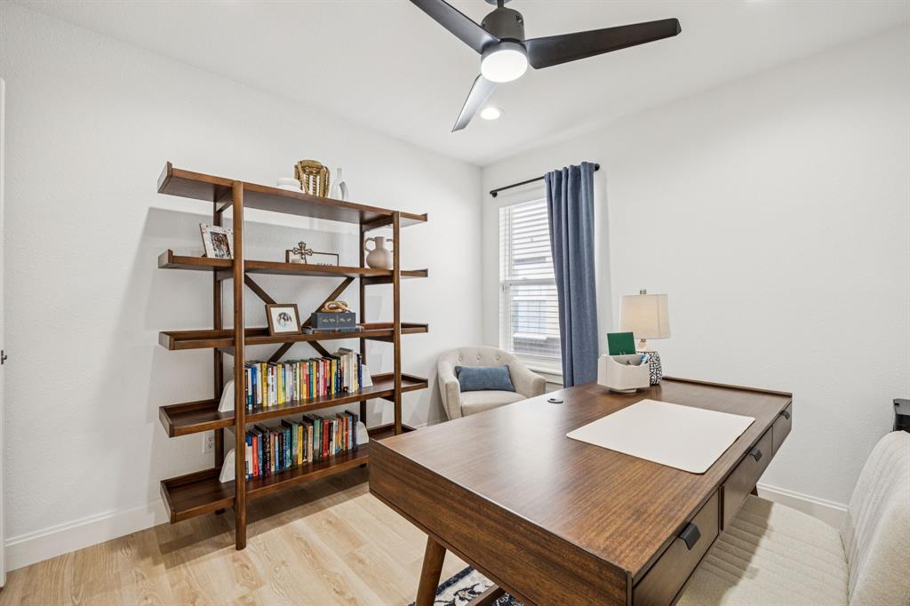 1609 Knight Trail Little Elm, TX 75036 - Photo 18 of 28 a living room with furniture a desk and a book shelf