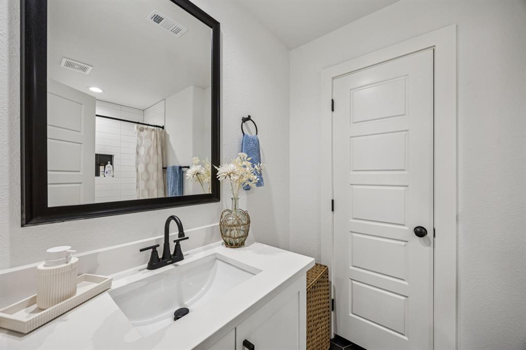 1609 Knight Trail Little Elm, TX 75036 - Photo 19 of 28 a bathroom with a sink and a mirror