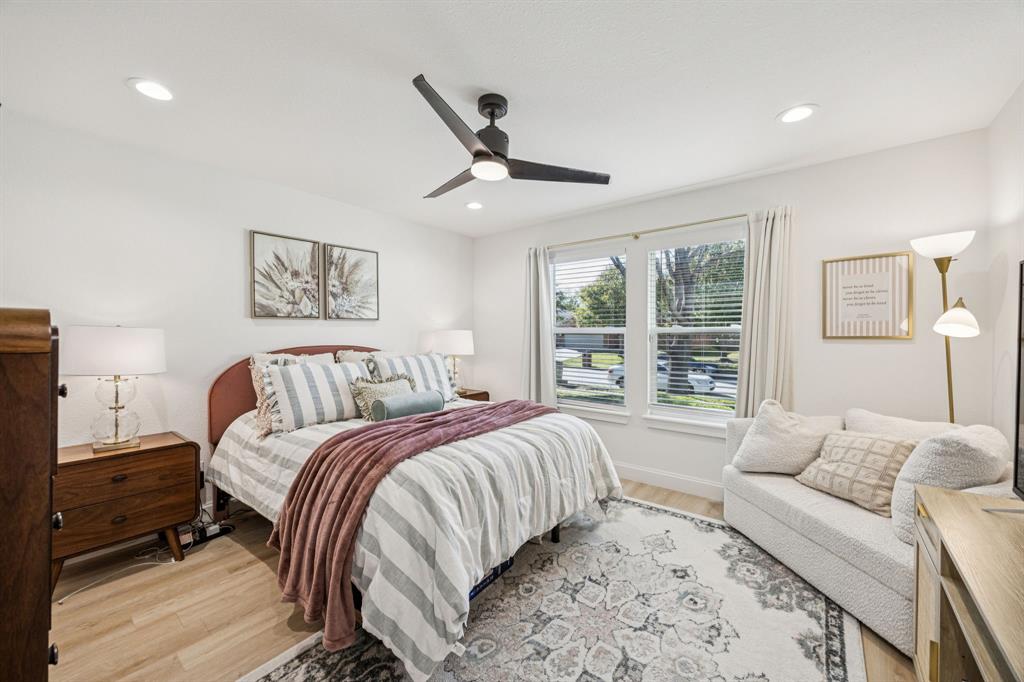 1609 Knight Trail Little Elm, TX 75036 - Photo 21 of 28 a spacious bedroom with a large bed and a couch