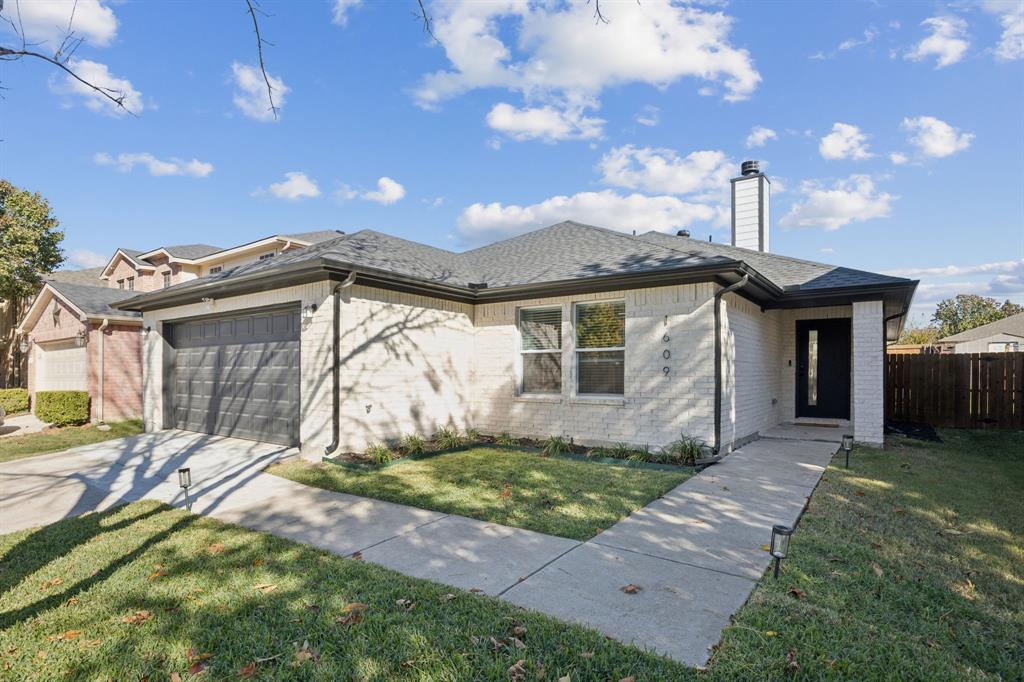 1609 Knight Trail Little Elm, TX 75036 - Photo 24 of 28 a front view of a house with a yard and garage