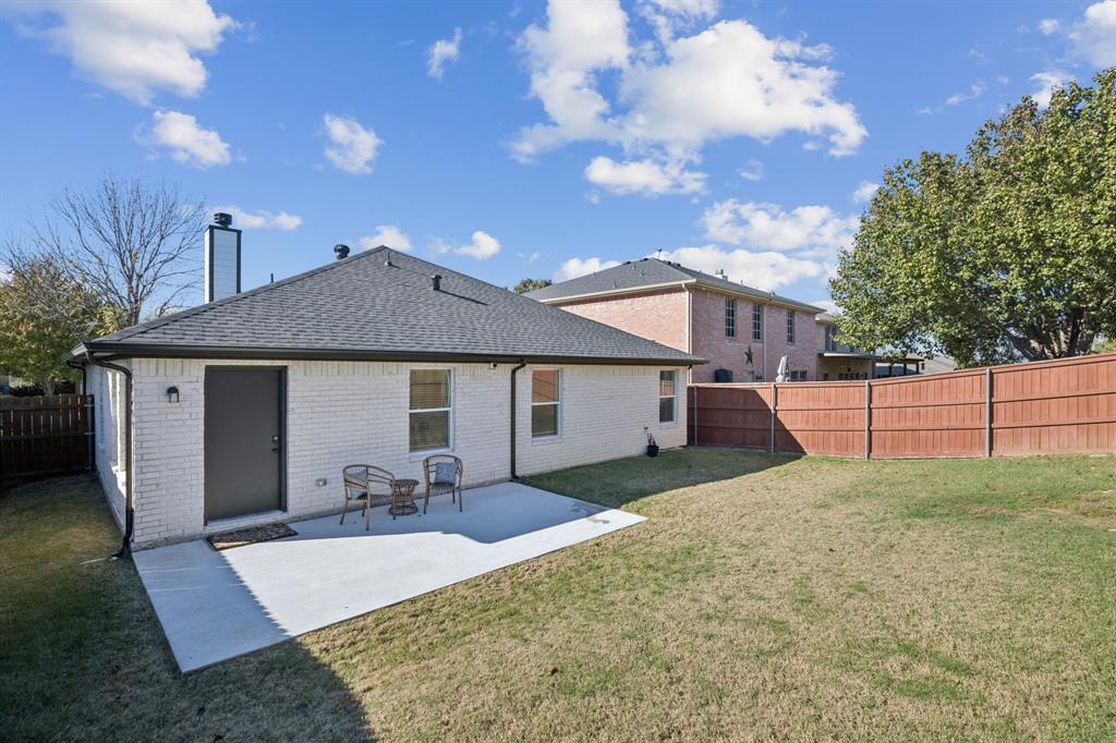 1609 Knight Trail Little Elm, TX 75036 - Photo 27 of 28 a front view of house with yard and trees in the background