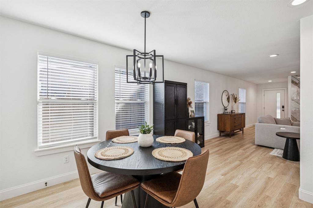 1609 Knight Trail Little Elm, TX 75036 - Photo 6 of 28 a view of a dining room with furniture window and wooden floor