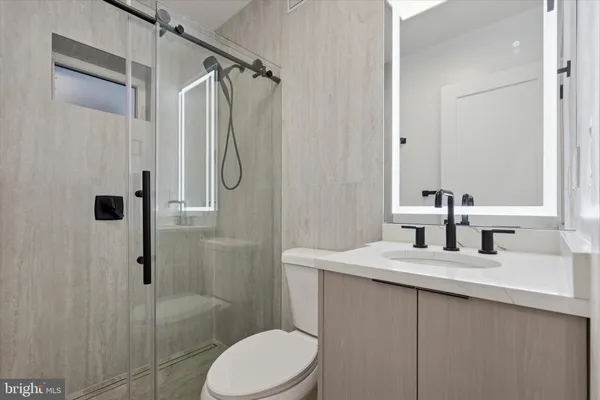 a bathroom with a sink toilet and shower