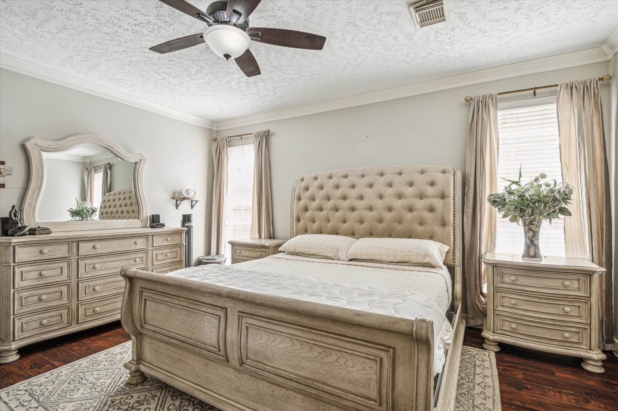 15314 Ripplewind Lane Houston, TX 77068 - Photo 12 of 24 a bedroom with a large bed and a chandelier fan
