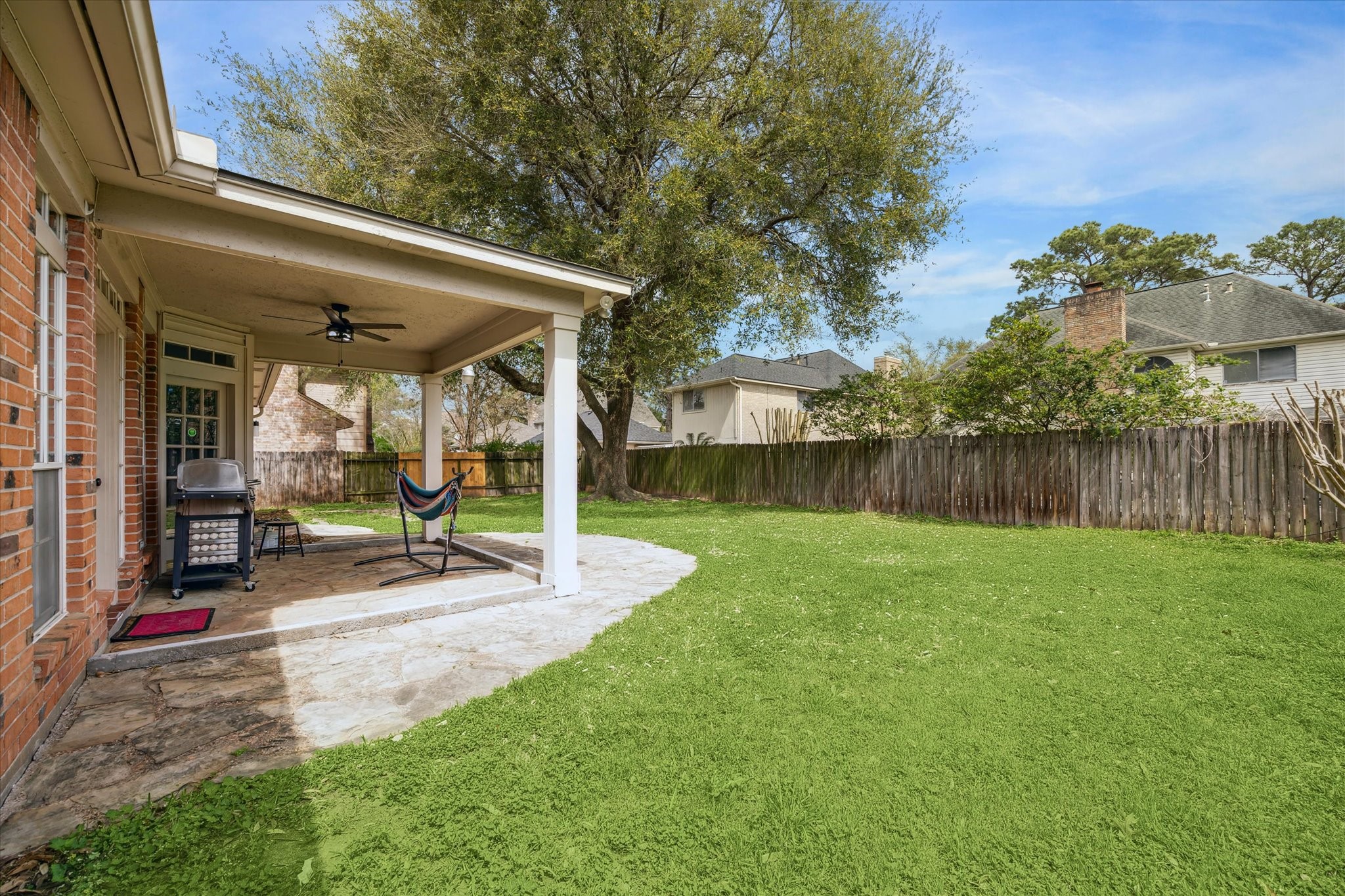 15314 Ripplewind Lane Houston, TX 77068 - Photo 23 of 24 a view of a backyard with sitting area and slide