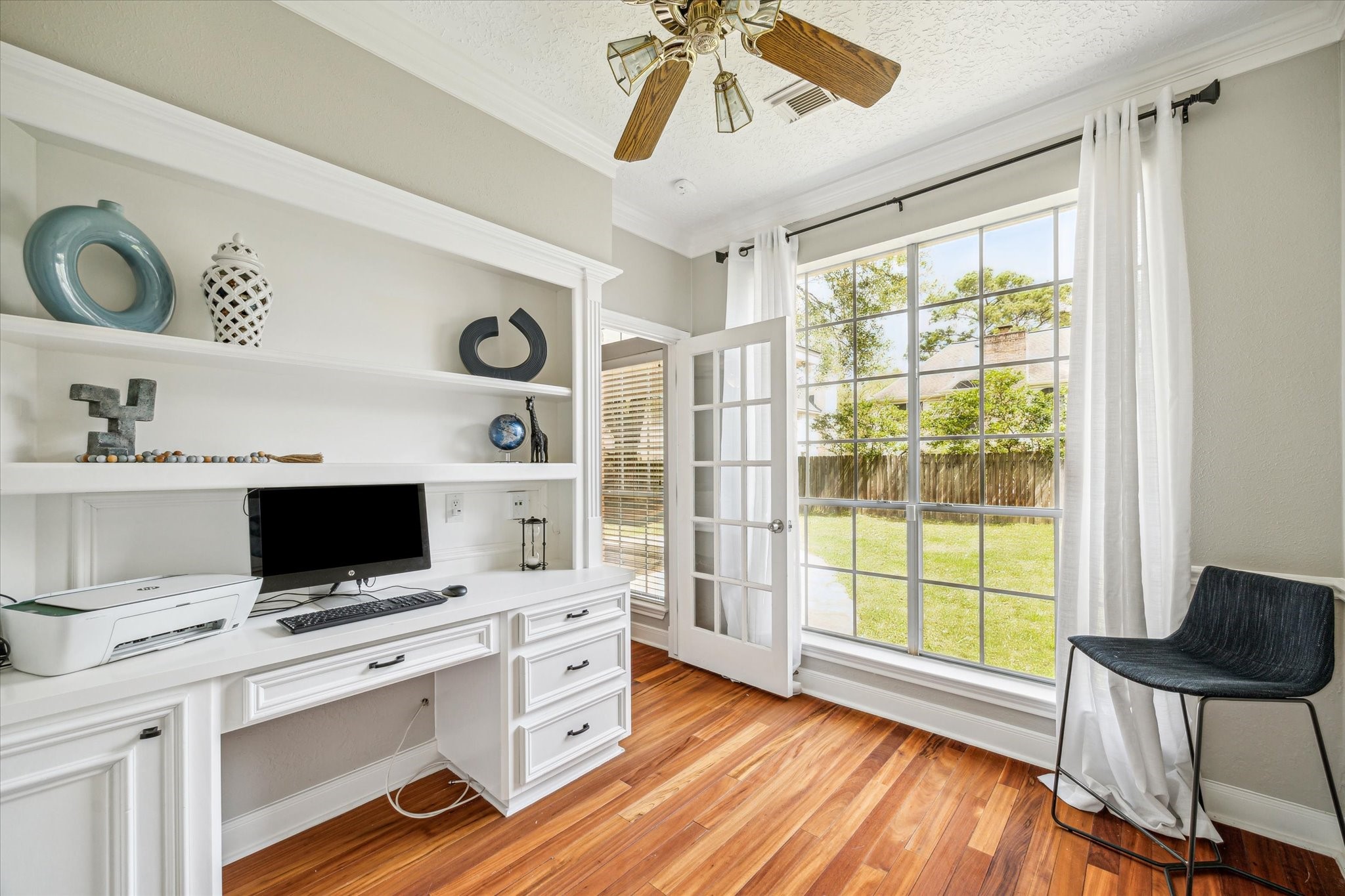 15314 Ripplewind Lane Houston, TX 77068 - Photo 4 of 24 a view of workspace with wooden floor and ceiling fan