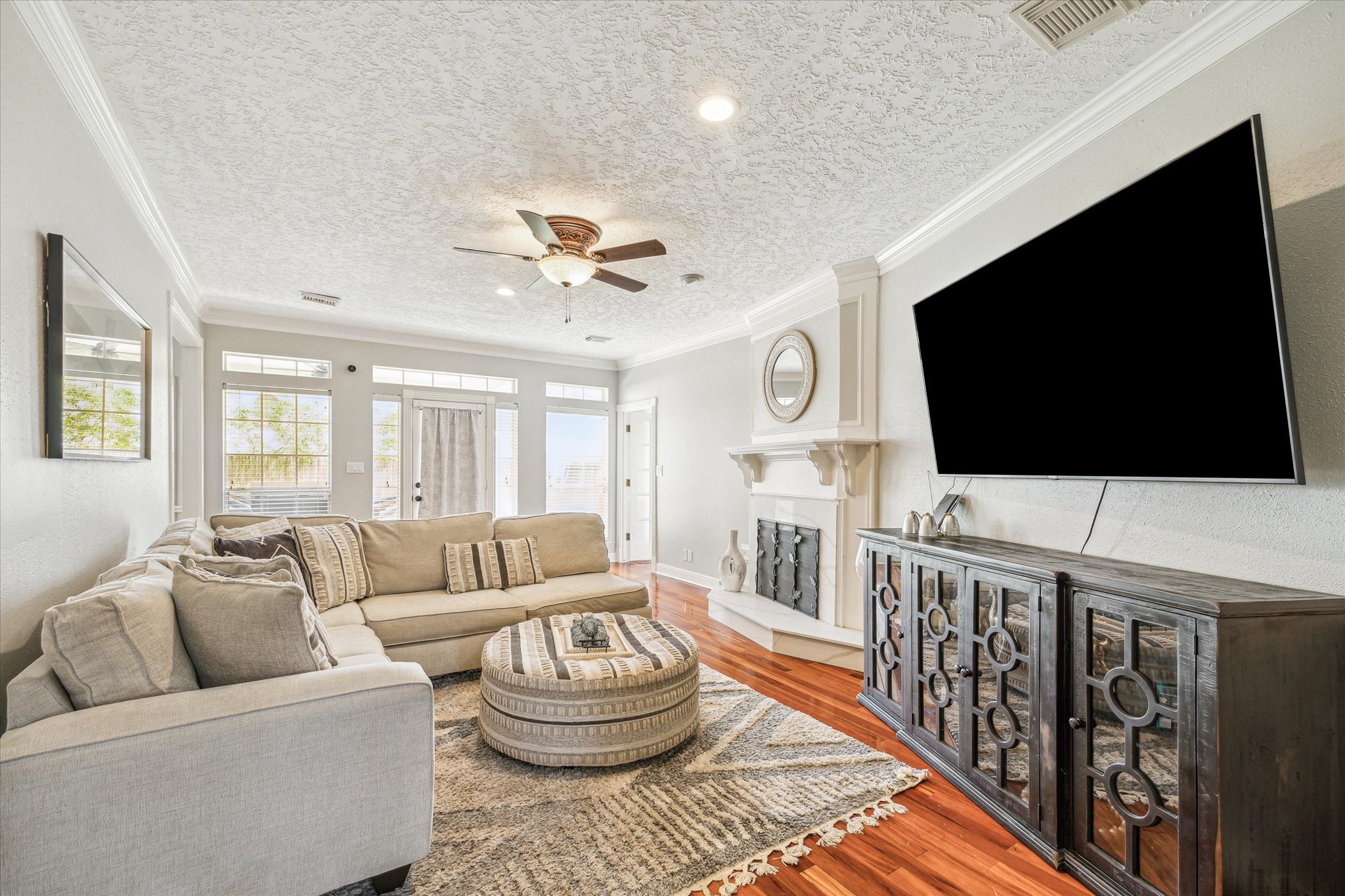 15314 Ripplewind Lane Houston, TX 77068 - Photo 6 of 24 a living room with furniture and a flat screen tv