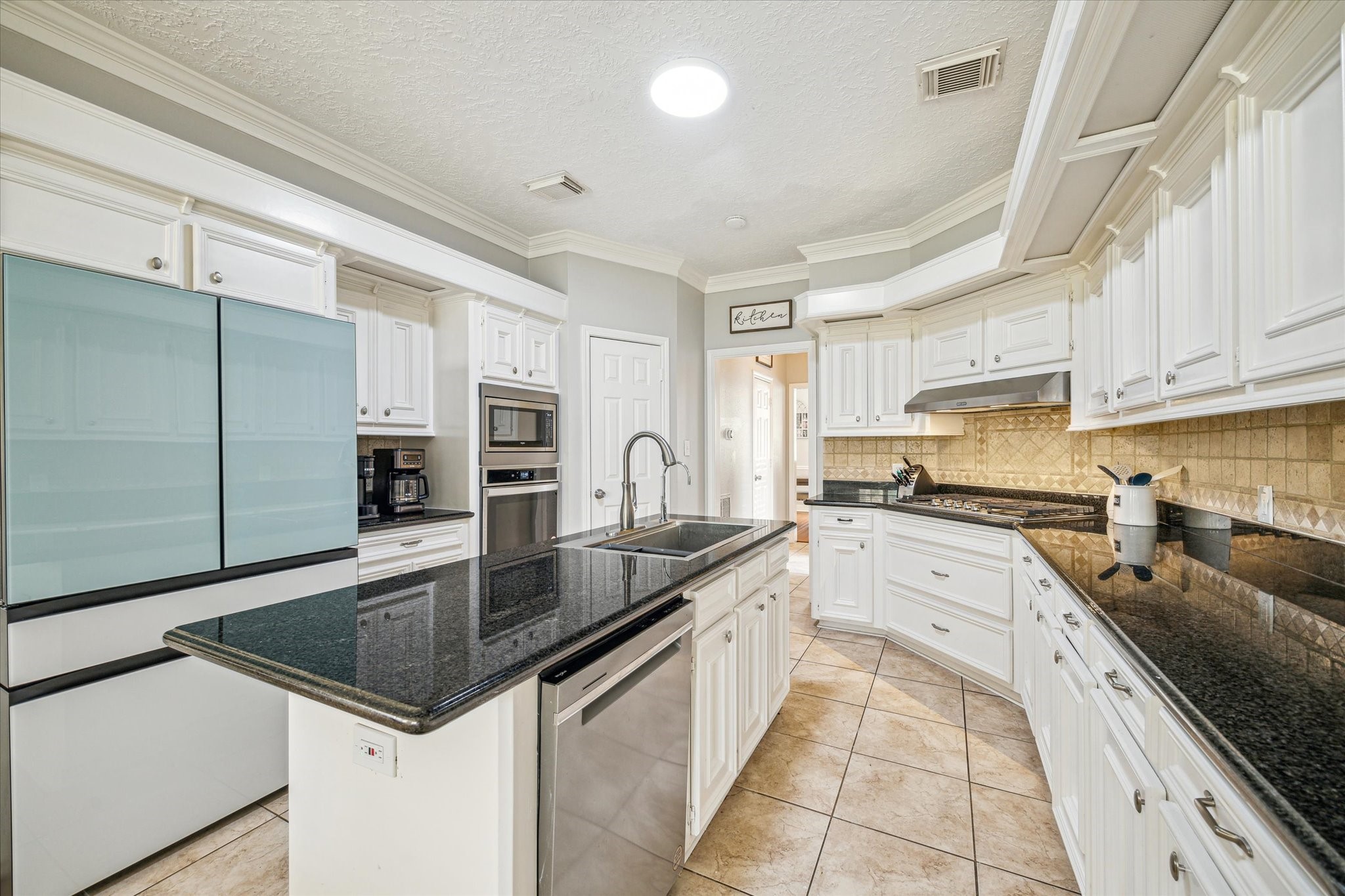15314 Ripplewind Lane Houston, TX 77068 - Photo 9 of 24 a kitchen with stainless steel appliances granite countertop a sink stove and refrigerator