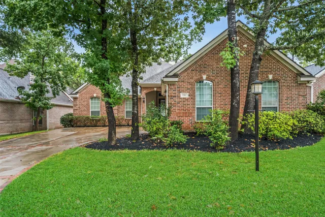a view of a house with a yard and a garden