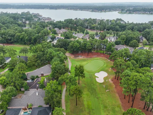 an aerial view of lake and residential houses with outdoor space