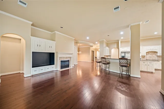 a view of kitchen with microwave a stove and wooden floor