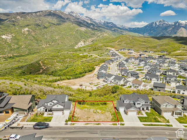 14673 South Ravine Rock Way East, Unit 720 Draper, UT 84020 - Photo 1 of 15 Aerial view of residential area with a mountainous background and property boundaries highlighted