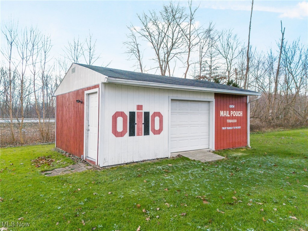 3696 Lynn Road Ravenna, OH 44266 - Photo 25 of 25 View of outbuilding featuring a garage and a lawn