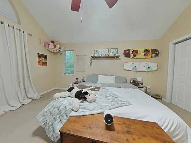 a bed sitting in a bedroom next to a window