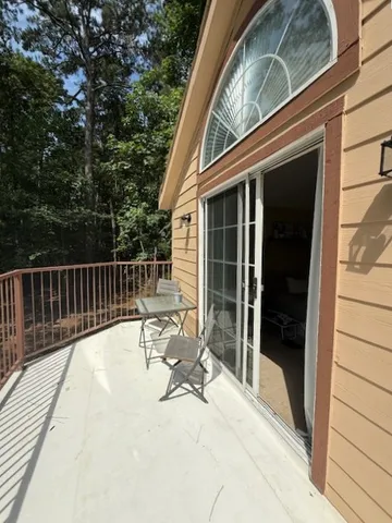 a view of balcony with wooden floor and outdoor seating