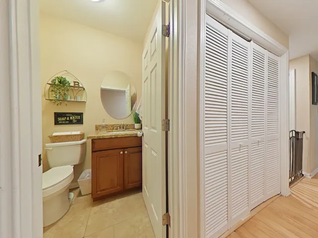 a bathroom with a toilet a sink and a window
