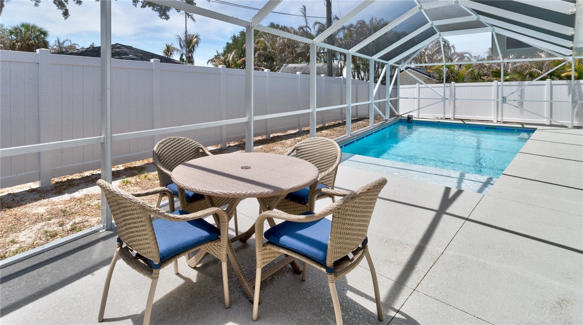 7989 143rd Street Sebastian, FL 32958 - Photo 20 of 30 a view of a patio with a table and chairs