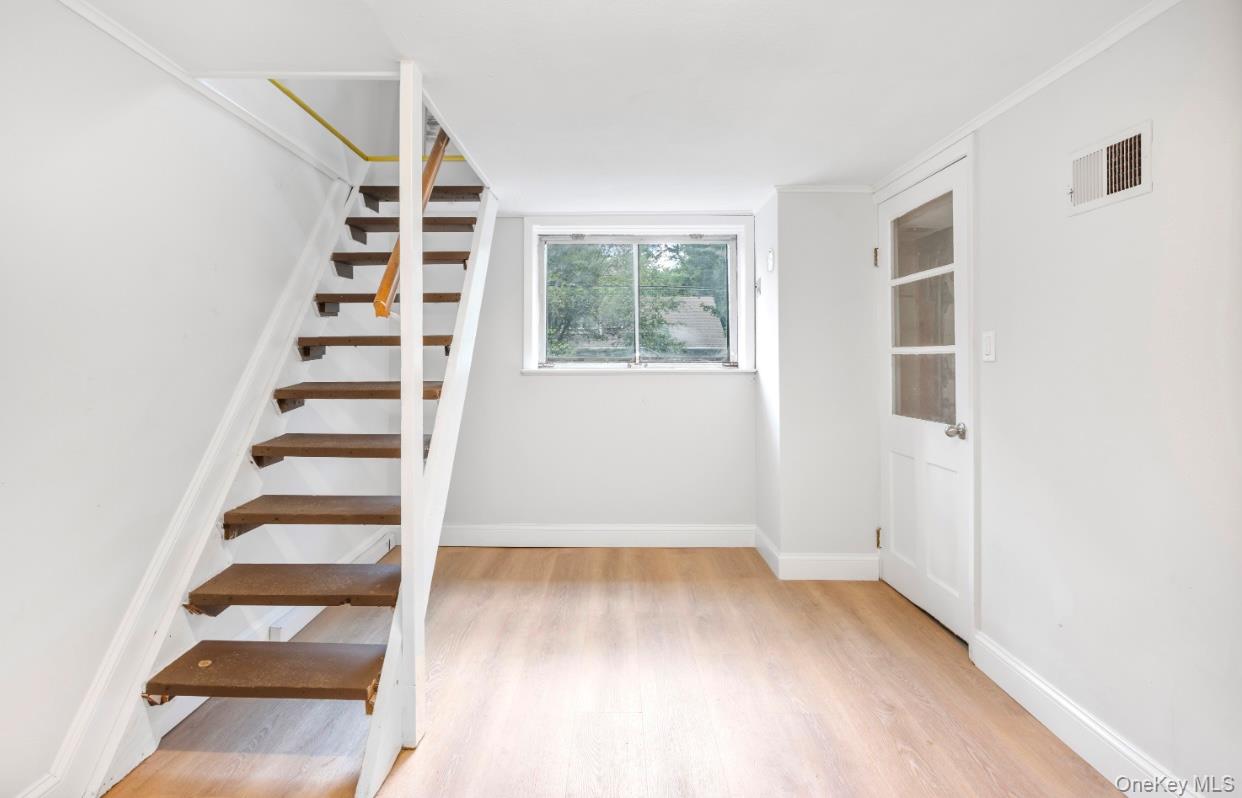 164 Maple Road Wading River, NY 11792 - Photo 18 of 19 Stairs featuring wood finished floors and baseboards