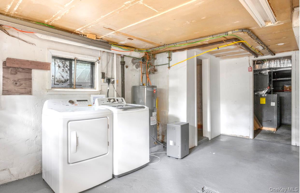 164 Maple Road Wading River, NY 11792 - Photo 19 of 19 Below grade area with independent washer and dryer, electric water heater, and heating unit