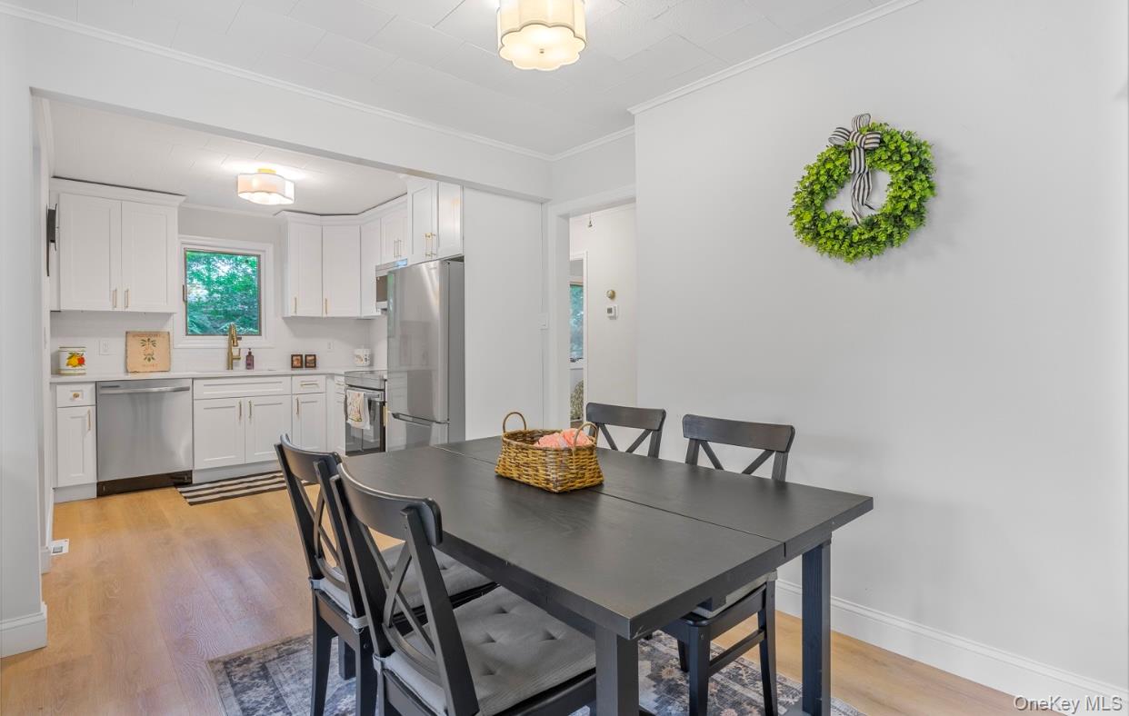 164 Maple Road Wading River, NY 11792 - Photo 9 of 19 Dining room featuring light wood finished floors and ornamental molding