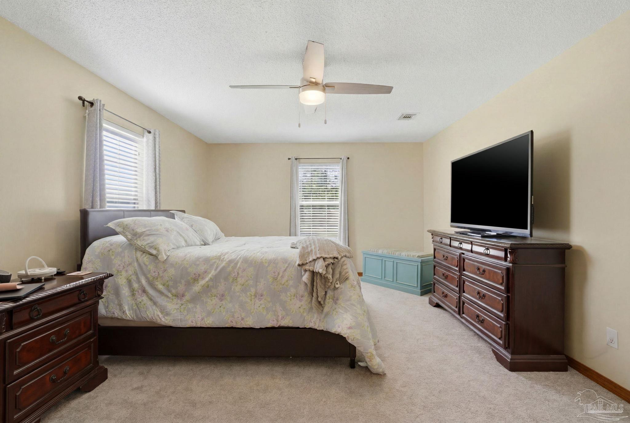 6870 Martin Road Milton, FL 32570 - Photo 31 of 48 a bedroom with a bed and a flat screen tv