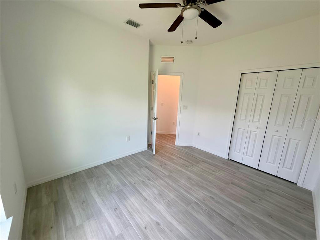14142 Appleton Boulevard Port Charlotte, FL 33981 - Photo 21 of 26 wooden floor in an empty room