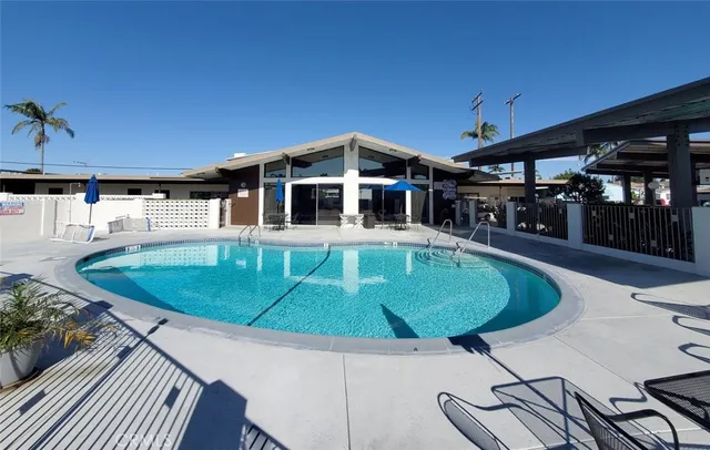 a view of a patio with table and chairs