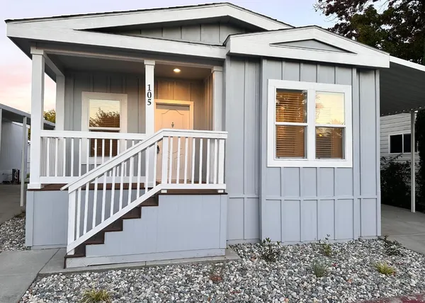a view of a house with wooden fence