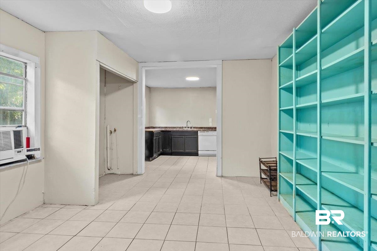 4918 Quimby Drive Mobile, AL 36619 - Photo 22 of 38 Corridor featuring a textured ceiling, light tile patterned floors, and a sink