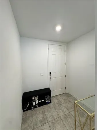 a room with a bed a couch and a window