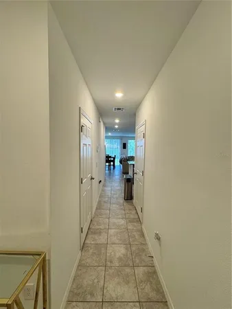 a hallway view with a couch