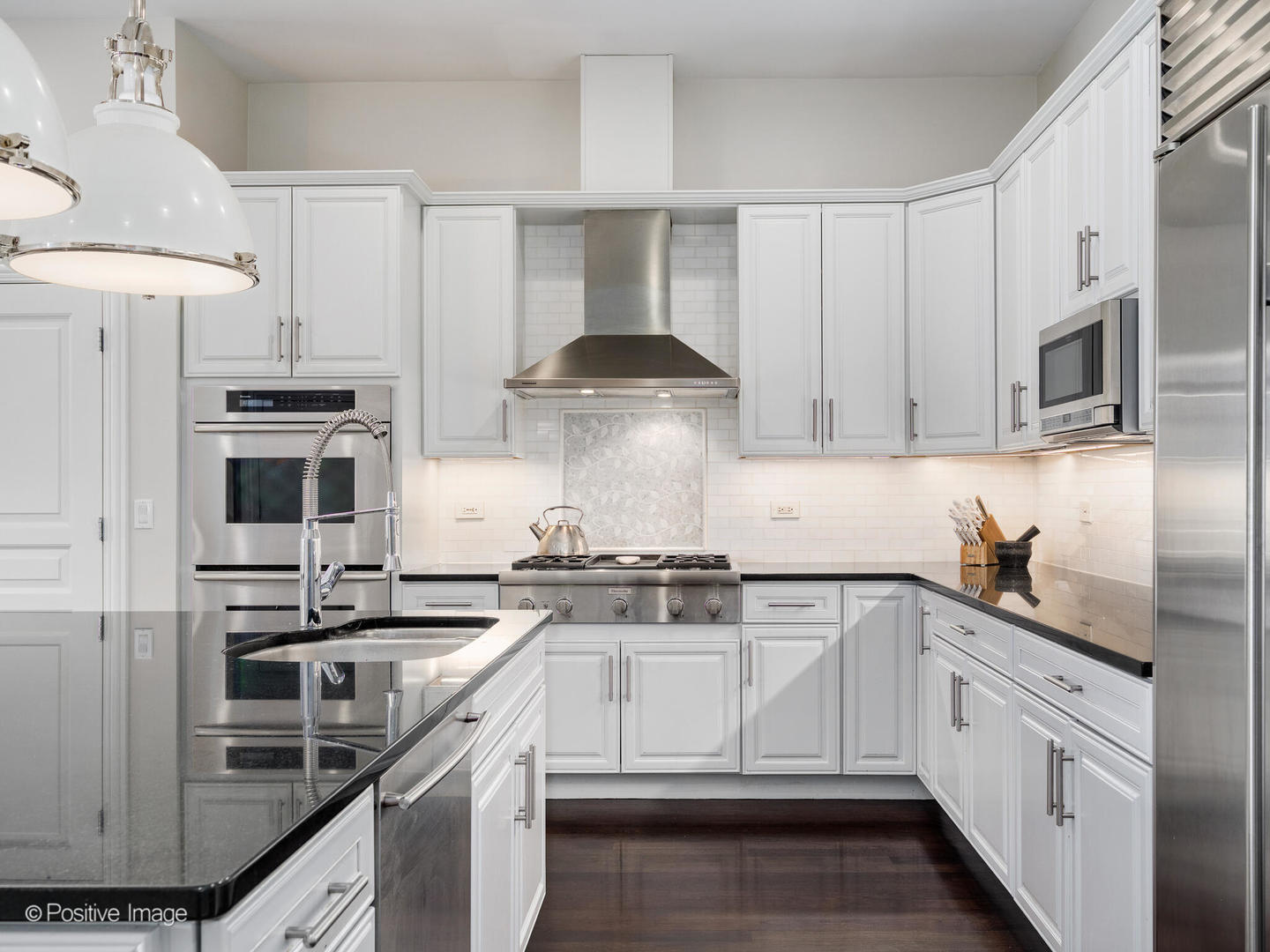 1359 West Fullerton Avenue, Unit PH Chicago, IL 60614 - Photo 16 of 33 a white kitchen with stainless steel appliances granite countertop a stove and a sink